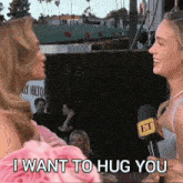 a woman talking into a microphone with the words " i want to hug you " below her