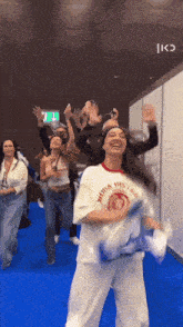 a group of people are dancing in a room with a sign that says exit