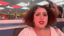 a woman with red lipstick is sitting in front of a mirror