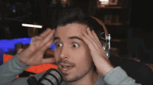 a man wearing headphones is making a funny face
