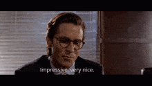 a man in a suit and tie is saying impressive very nice