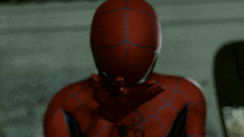 a close up of a spiderman 's face with his hand outstretched