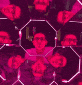 a man is reflected in a kaleidoscope with pink lights
