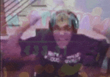 a blurry picture of a man wearing headphones and a shirt that says ' purple '