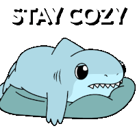a cartoon shark is laying on a pillow with the words stay cozy above it