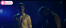a couple of men are standing next to each other in a dark room with police lights in the background .
