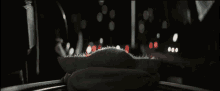 a baby yoda is laying on a table in the dark