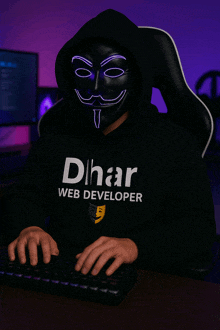 a man wearing a hoodie that says dhar web developer is typing on a keyboard