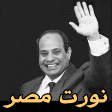 a man in a suit and tie is waving his hand in front of a black background