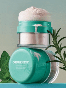 two containers of organist powder are stacked on top of each other on a table