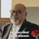 a man with glasses and a beard says aasoon nikal aay aasoon