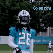 a football player in a blue jersey with the number 26