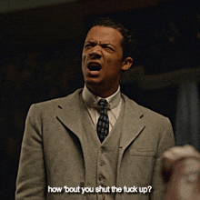 a man in a suit and tie is asking how about you shut the fuck up