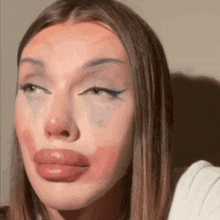 a close up of a woman 's face with a big lip