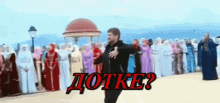 a man is dancing in front of a crowd with the word dokte written in red letters