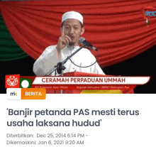 a man speaking into a microphone with the words cermah perpaduan ummah on the top