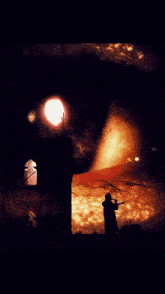 a man is standing in front of a large fire