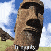 a statue of a man says hi monty in a field