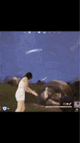 a woman in a white dress is playing a video game with a parachute .