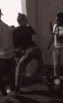 a group of people are dancing in a room with a man wearing a headband that says nike on it .