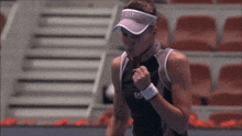 a woman wearing a visor with ea7 written on it