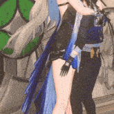 a woman in a blue dress is hugging a man in a black suit