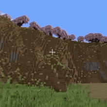 a minecraft character is standing in the grass in front of a hill .