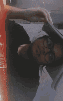 a blurry picture of a person laying on their back with the word supreme on their shirt