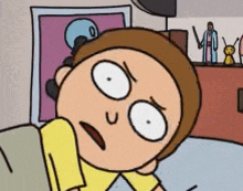 a cartoon character with a surprised look on his face is laying on a bed .