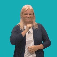 a woman wearing a eversa shirt is making a face