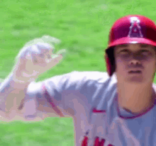a close up of a baseball player wearing a helmet with the letter a on it
