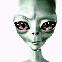 a close up of a grey alien with red eyes on a white background