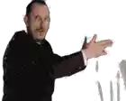 a man in a suit is making a funny face