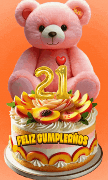 a pink teddy bear sits on top of a birthday cake
