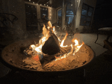 a fire is burning in a fire pit in a dark room