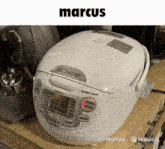 a white rice cooker says marcus on the top