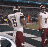 a football player named daniels is standing on a field