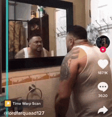 a man is looking at himself in a bathroom mirror with a time warp scan app open