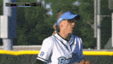 a female softball player wearing a blue visor with the word bandits on it