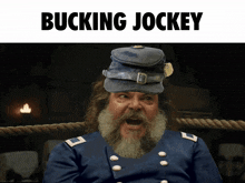 a man with a beard is wearing a hat that says bucking jockey on it