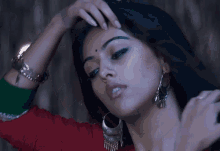 a close up of a woman 's face with earrings on
