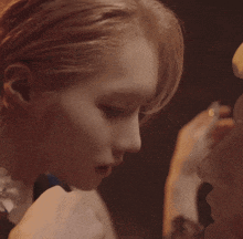 a close up of a woman kissing a man 's face