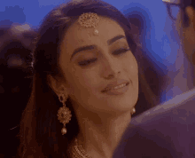 a close up of a woman 's face with a man behind her