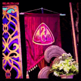 a purple banner with a dragon on it hangs from a rope