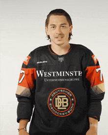 a man is wearing a black jersey with the number 7 on it