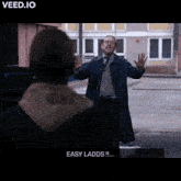 a man in a trench coat says " easy ladds "