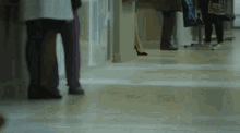 a group of people standing in a hospital hallway .