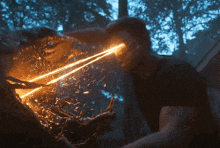a man is being attacked by a monster with a light coming out of his eyes