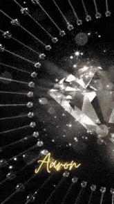 a black background with a diamond and the name aaron on it
