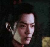 a close up of a young man 's face with his tongue sticking out
